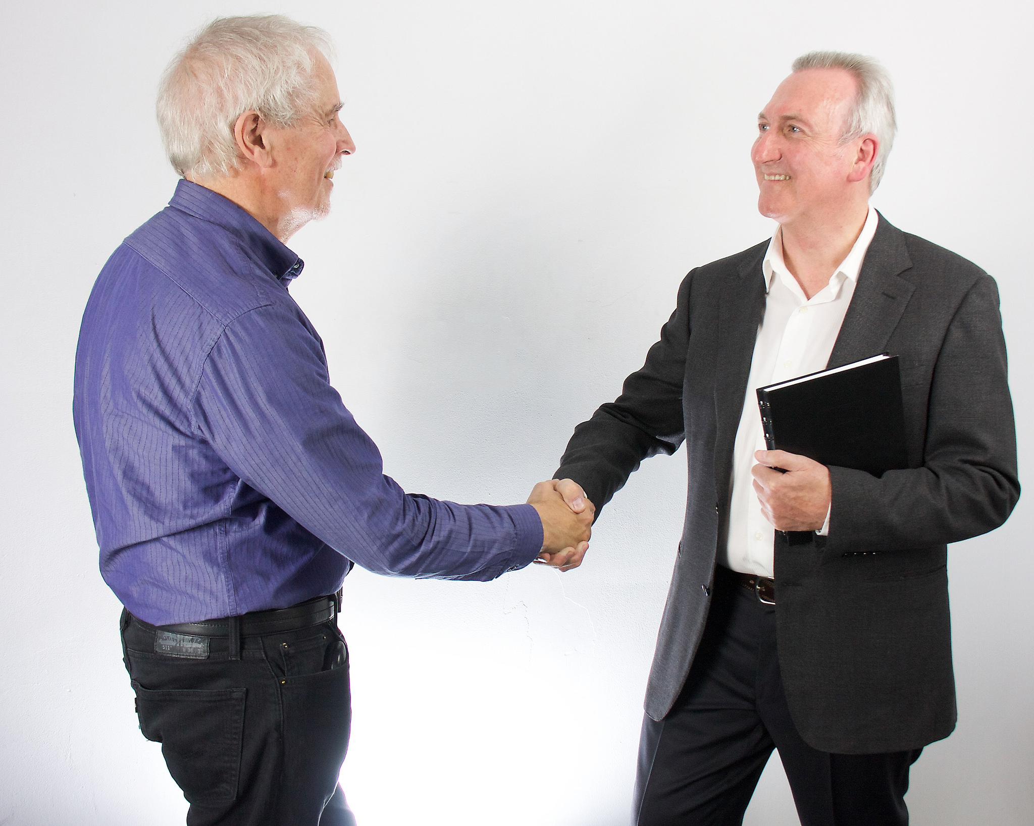 Mike shaking hands with a client